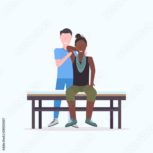 african american woman sitting on bed masseur therapist in uniform doing healing treatment massaging patient body manual therapy physiotherapy concept