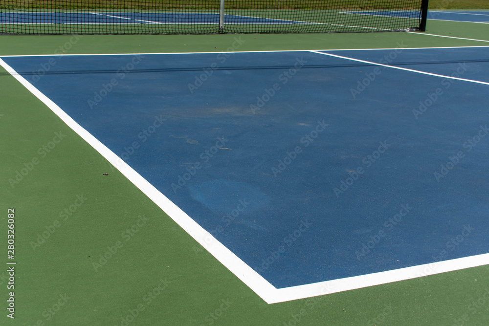 Recreational sport of pickleball court in Michigan, USA looking at an empty blue and green new court at a outdoor park. Ground View. Recreational sport of pickleball court in Michigan, USA looking at an empty blue and green new court at a outdoor park. Ground View.