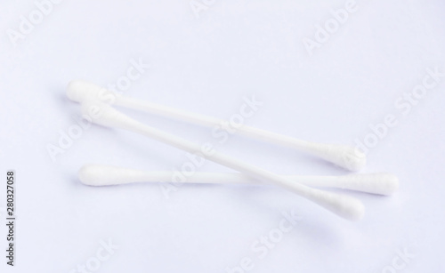 Three cotton buds put on white background.