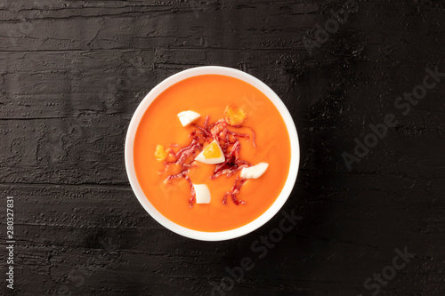 Salmorejo  Spanish cold tomato soup  shot from above on a black background with a place for text