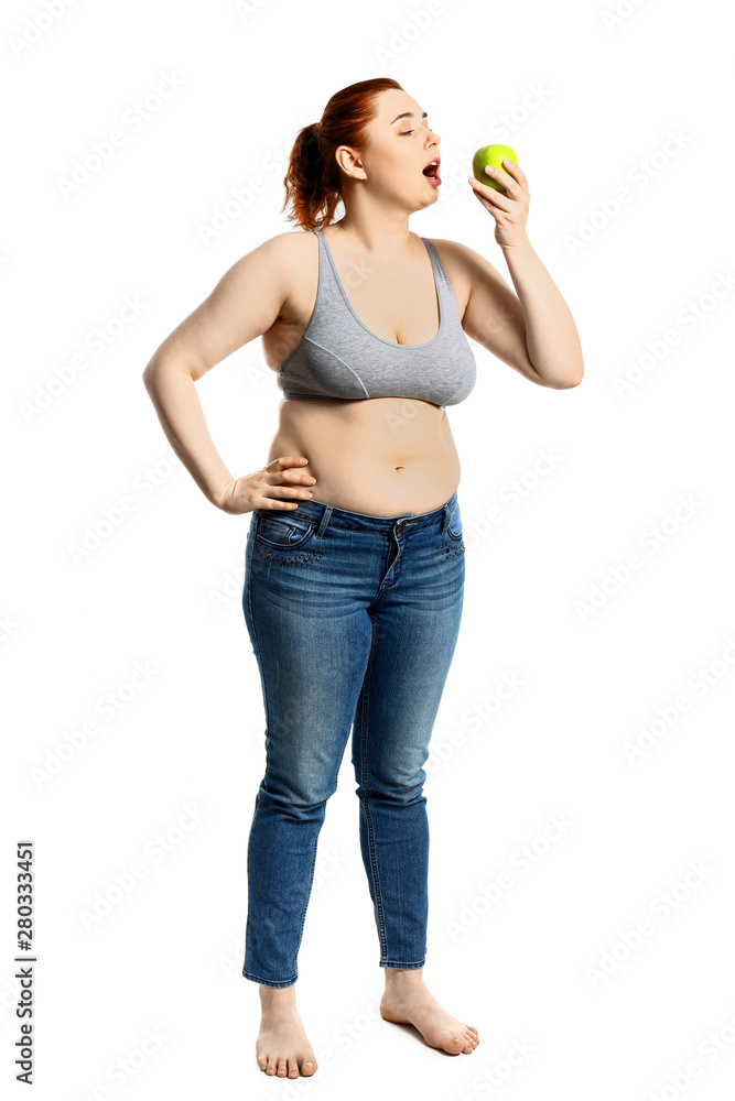 Overweight woman with apple on white background. Weight loss concept Overweight woman with apple on white background. Weight loss concept