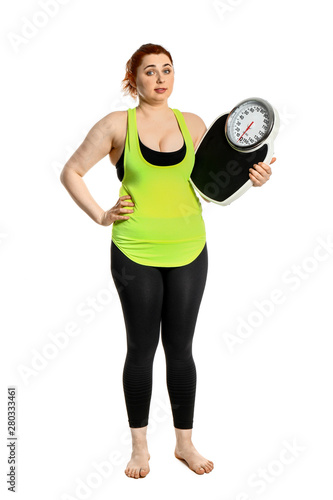 Overweight woman with scales on white background. Weight loss concept © Pixel-Shot