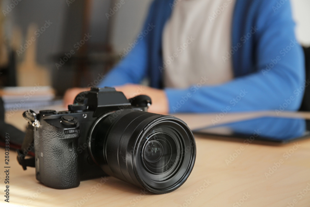Modern photo camera on table Modern photo camera on table