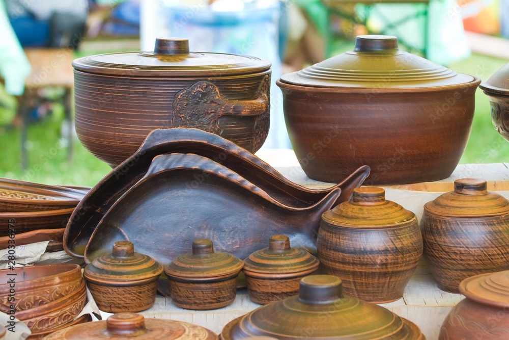 traditional and modern style handmade ceramic clay plates, pots and pans on sale at ethno festival fair traditional and modern style handmade ceramic clay plates, pots and pans on sale at ethno festival fair