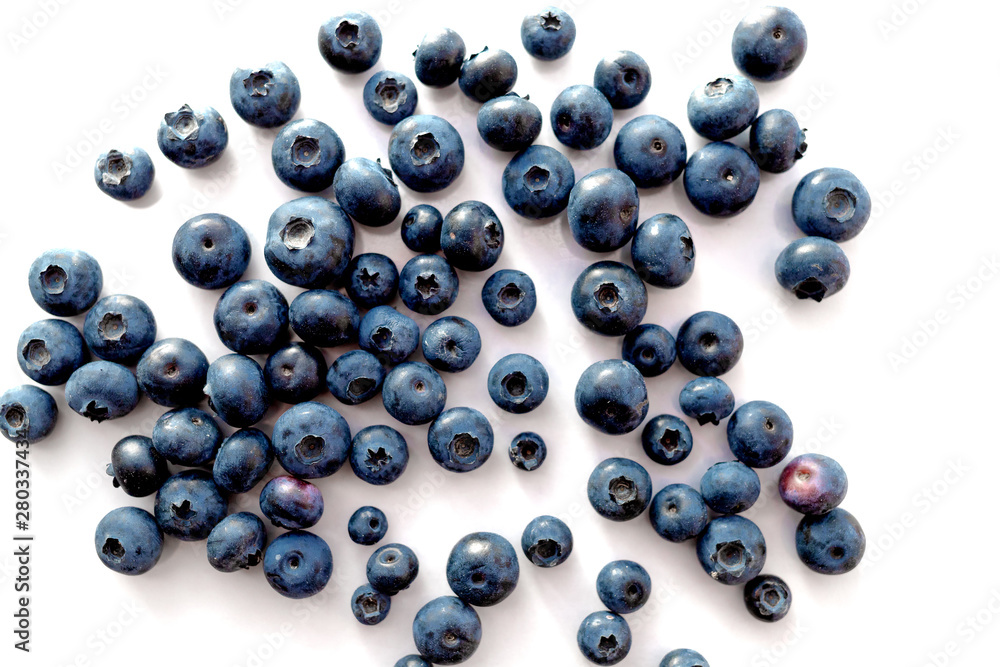 Blueberries scattered on a white table. Blueberries scattered on a white table.