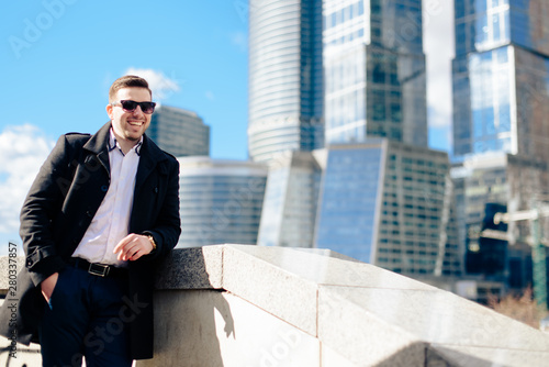 stylish young male businessman on the background of the cityscape