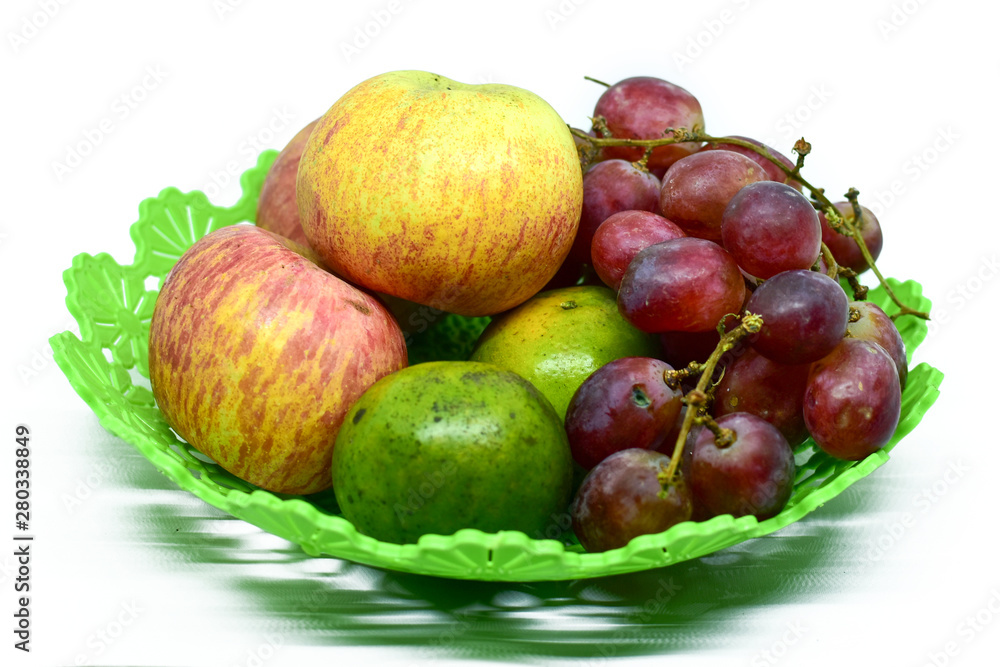 Fresh juicy fruits on the plastic tray, isolated on white background Fresh juicy fruits on the plastic tray, isolated on white background
