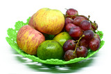 Fresh juicy fruits on the plastic tray, isolated on white background