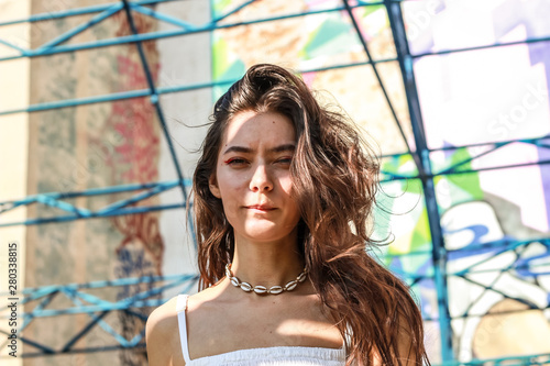 Young beautiful lady wearing a stylish white top.Portrait shooting of a stylish girl.Trends summer 2019. photo