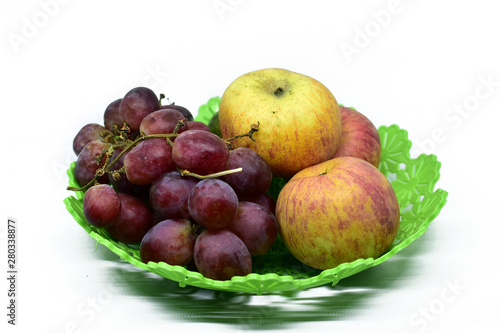 Fresh juicy fruits on the plastic tray, isolated on white background