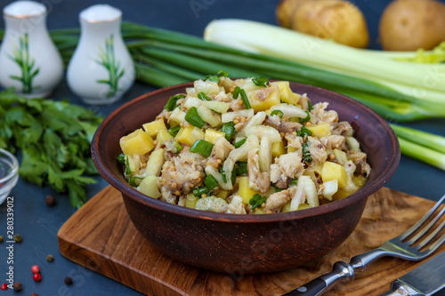 Salad with potatoes, mackerel and celery, seasoned with mustard and olive oil, horizontal photo