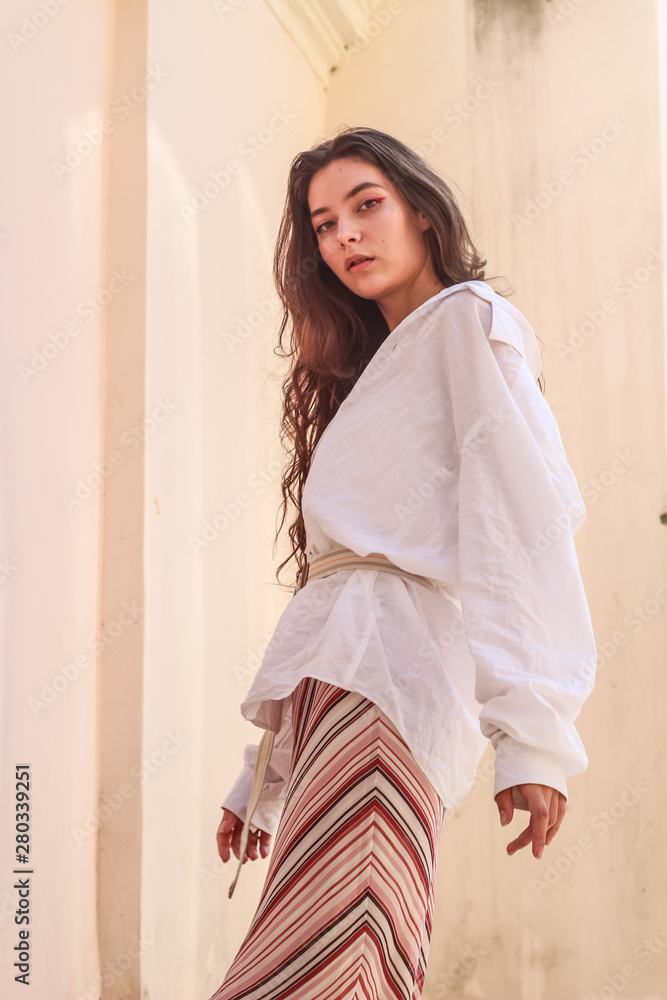 Young beautiful lady wearing a stylish white shirt.Portrait shooting of a stylish girl.Trends summer 2019. Young beautiful lady wearing a stylish white shirt.Portrait shooting of a stylish girl.Trends summer 2019.