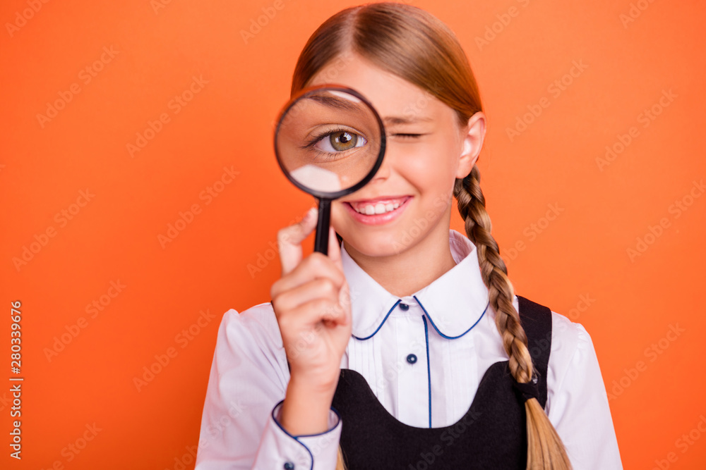 Close-up portrait of her she nice attractive cheerful smart clever genius pre-teen girl holding in hand loupe searching new solution isolated over bright vivid shine orange background