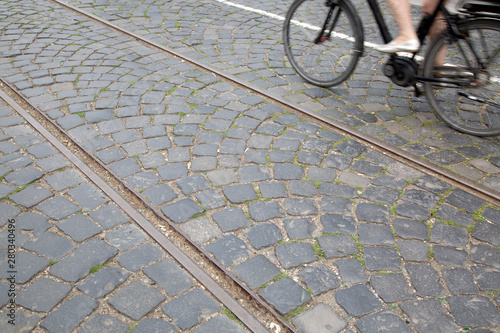 Cyclist and Railway Track on Cobblestone Background; Frankfurt