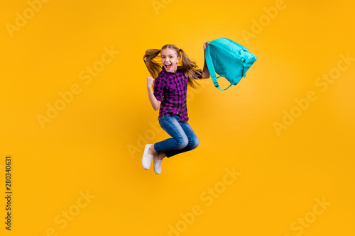 Full length photo of small pupil jump high finally holidays hooray wear casual checkered shirt jeans denim isolated yellow background