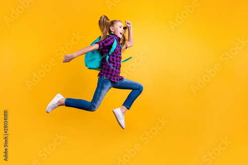 Full size profile photo of little pupil jump high holidays wear casual checkered shirt jeans denim isolated yellow background