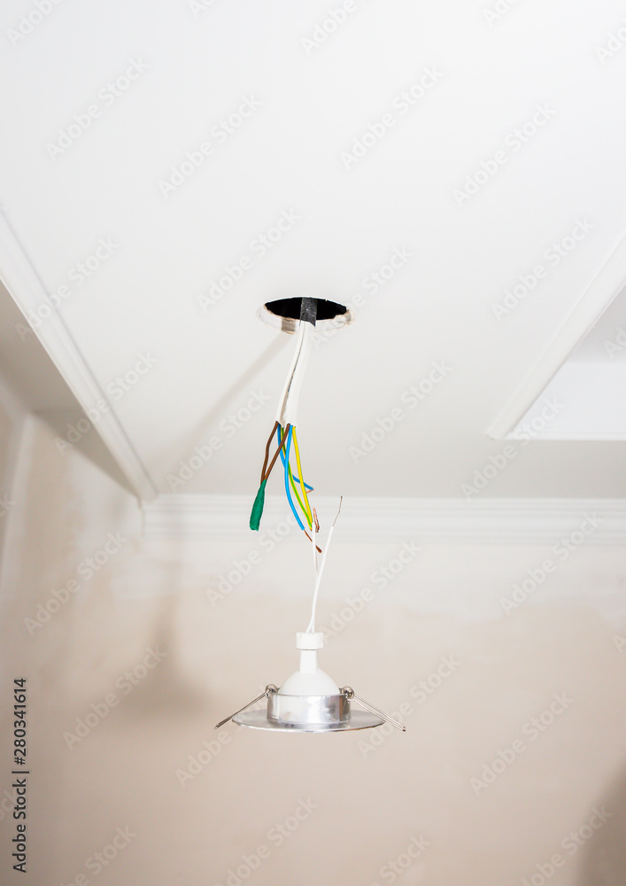 Wires and holes for light bulb in the ceiling. Electricity maintenance repair works in the flat. Restoration indoors. Wires and holes for light bulb in the ceiling. Electricity maintenance repair works in the flat. Restoration indoors.