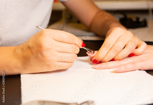 Woman is making a manicure. Salon procedures at home. Beautiful hands and nails.