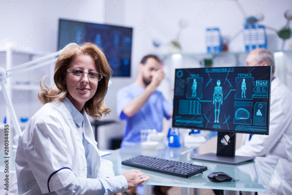 Portrait of middle age female engineer looking at the camera in a science laboratory Portrait of middle age female engineer looking at the camera in a science laboratory