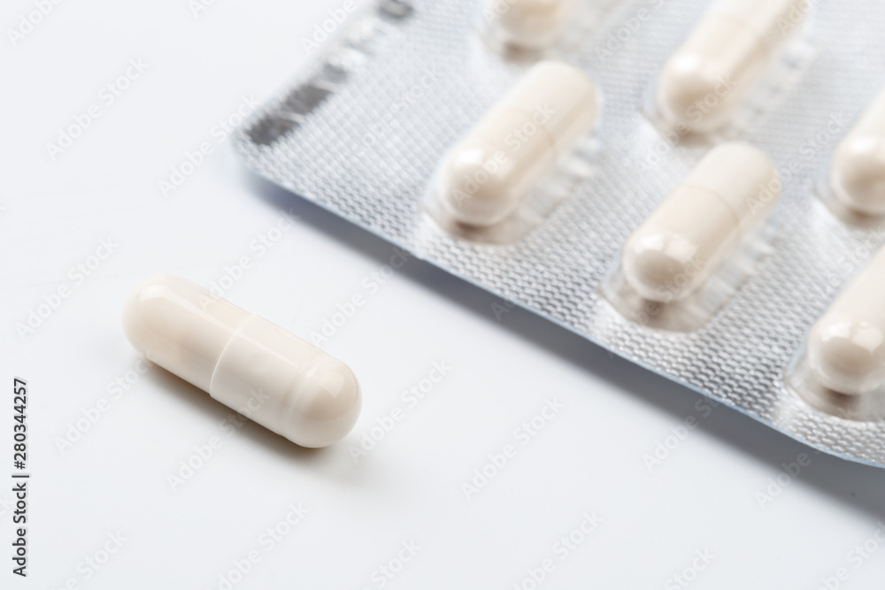 Pile of white capsules probiotic powder inside. Copy space. High resolution product. Health care concept - Image Pile of white capsules probiotic powder inside. Copy space. High resolution product. Health care concept - Image