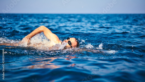Swimmer training on the open sea / ocean. © astrosystem