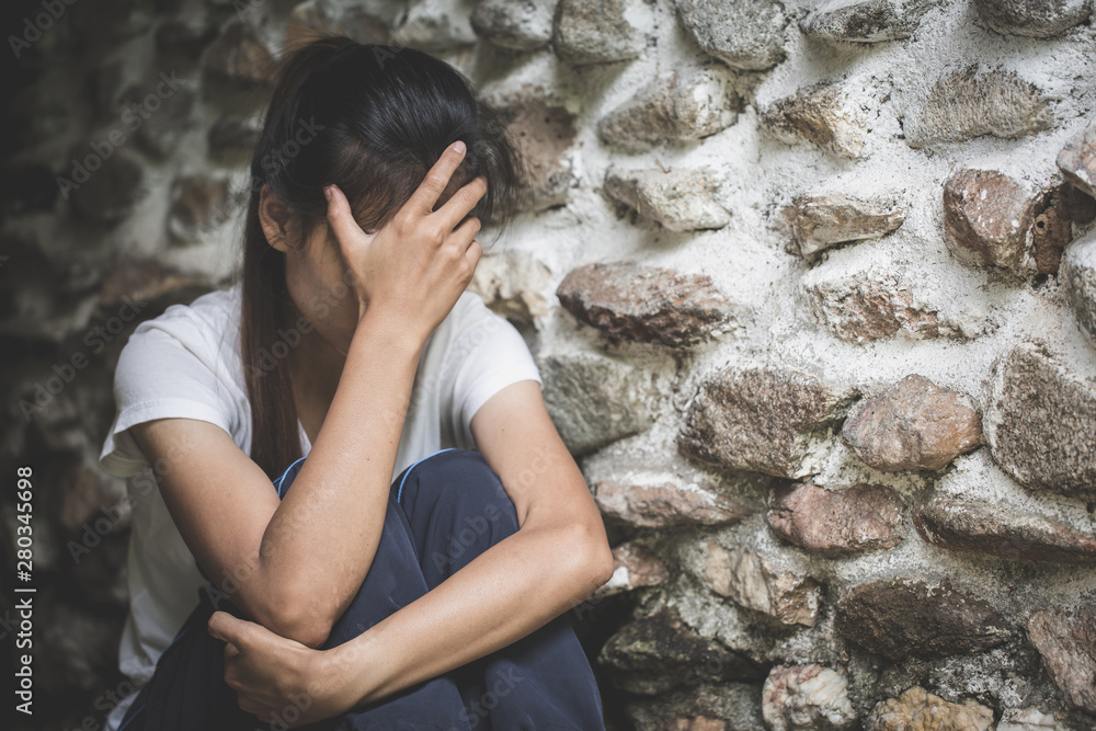 Depression or domestic violence Concept, Black and white image of a young woman crying and covering her face useful to illustrate stress. Depression or domestic violence Concept, Black and white image of a young woman crying and covering her face useful to illustrate stress.