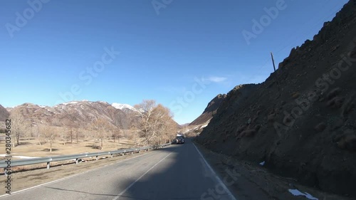 Driving along mountain asphalt road Chuysky Tract along Kurai Ridge on Altai betveen Kosh-Agach and Kurai intermountain hollows photo