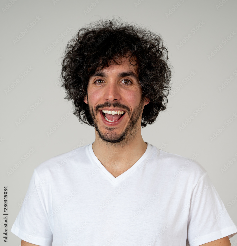 Portrait of attractive cheerful young man with smiling happy face. Human expressions and emotions Portrait of attractive cheerful young man with smiling happy face. Human expressions and emotions