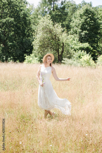 Beautiful woman in white vintage dress with a long train
