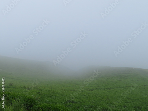 Misty grass hills lying across Aso Caldera viewed from Daikanbo