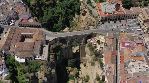 Aerial view of cityscape of Ronda, famous historic city with impressive arch bridge Puente Nuevo over gorge El Tajo - landscape panorama of Andalusia from above, province of Malaga, Spain, Europe