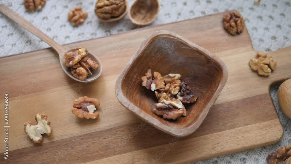 Walnuts Falling In Wooden Bowl. Slow Motion. Walnuts Falling In Wooden Bowl. Slow Motion.