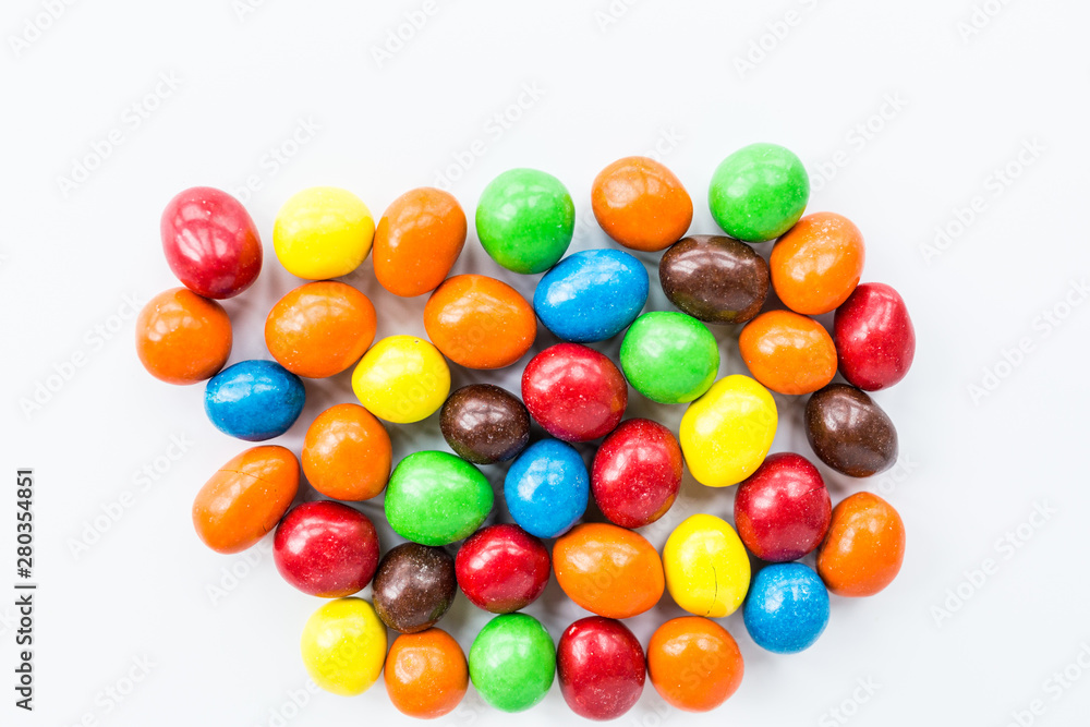 Candy lying on white background. Bright and Colorful sweets top view. Flat lay image. Copy space template. Unhealthy eating concept Candy lying on white background. Bright and Colorful sweets top view. Flat lay image. Copy space template. Unhealthy eating concept