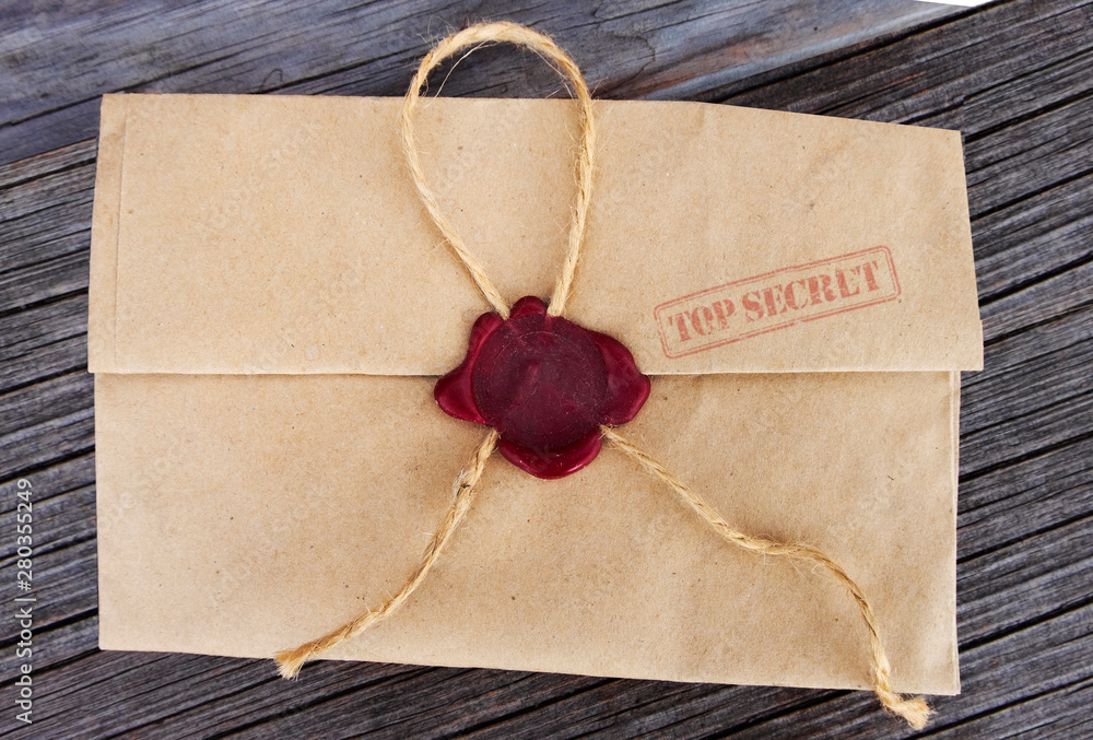 Retro envelope sealed with a secret seal on a black background. Retro envelope sealed with a secret seal on a black background.
