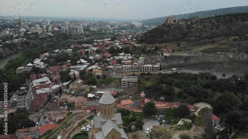 Aerial video of the Old Tbilisi center from above. Drone top view of historical part of city Dzveli Tbilisi. Kura or Mtkvari river below.