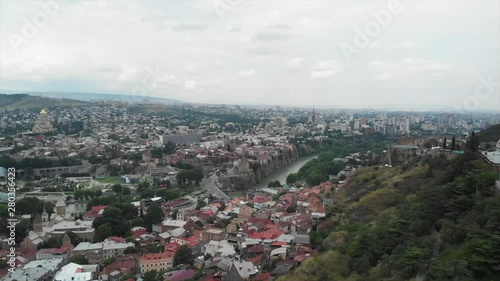 Aerial video of the Old Tbilisi center from above. Drone top view of historical part of city Dzveli Tbilisi. Kura or Mtkvari river below.
