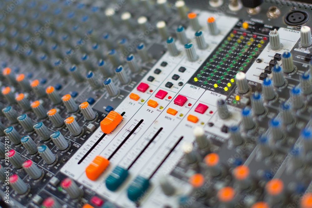 Analog sound mixer with selected focus. Professional audio mixing console radio and television broadcasting. Horizontal shot. Analog sound mixer with selected focus. Professional audio mixing console radio and television broadcasting. Horizontal shot.