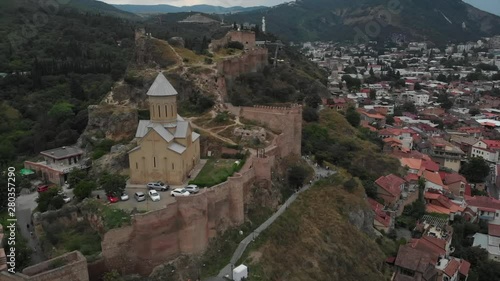 Aerial video of the Old Tbilisi center from above. Drone top view of historical part of city Dzveli Tbilisi. Kura or Mtkvari river below.
