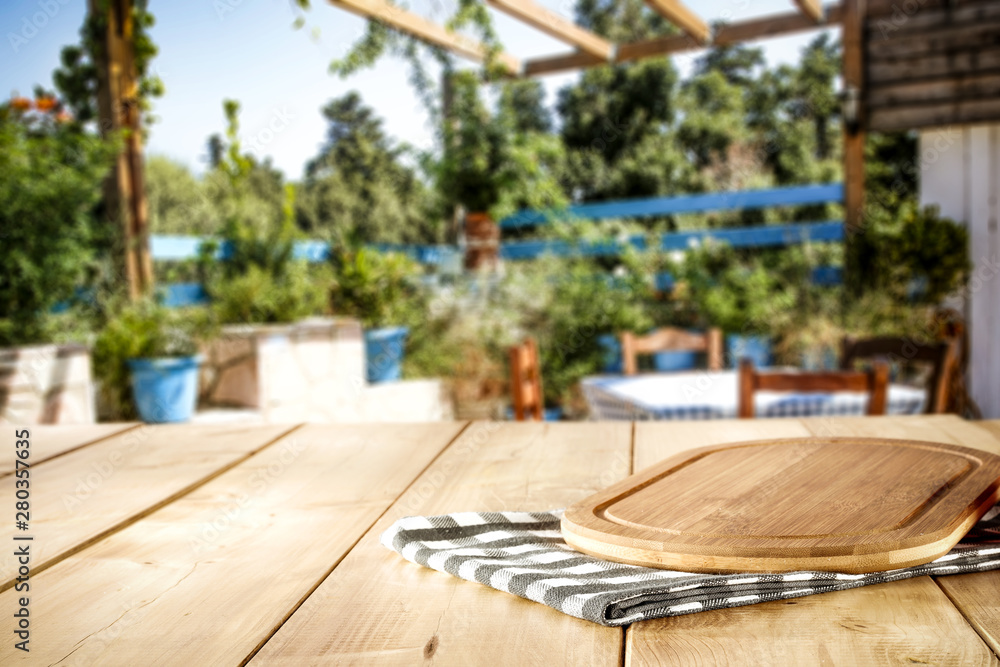 Wooden table of free space and summer restaurant background 