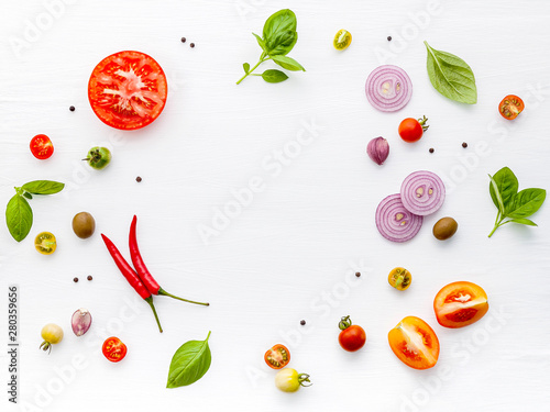The ingredients for homemade pizza on white wooden background.