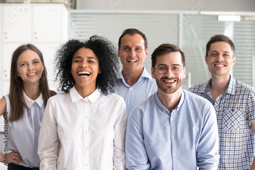 Laughing diverse office workers group, multiracial employees