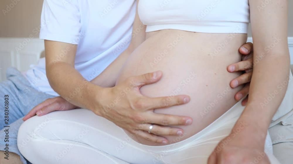 Man Hands Touching And Caressing Belly Of His Pregnant Woman Man Hands Touching And Caressing Belly Of His Pregnant Woman