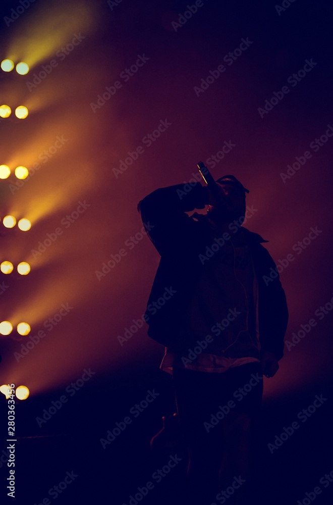 Silhouette Of Rap Singer With Microphone In Hand Vocalist Performing