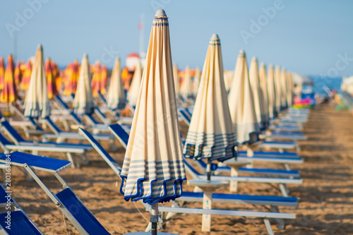 Obraz na płótnie Beach in Rimini, Italy. Umbrellas on sandy beach in resort city Rimini on sunny morning w salonie