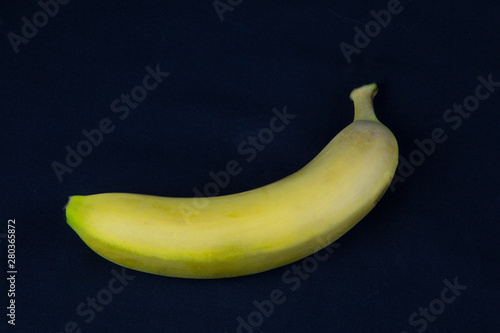 Yellow banana on black background. Fruits. Healthy diet.