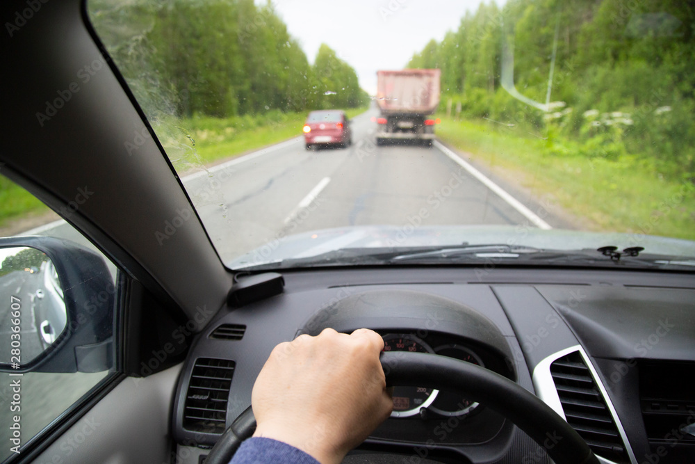 Overtaking car. Dangerous maneuver. Driving a car on the highway.