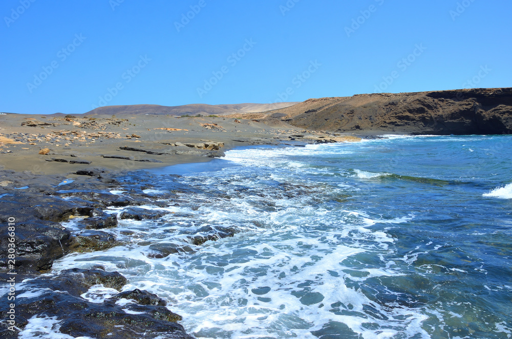 Fototapeta premium Empty Black Sand and Rocky Beach in Fuerteventura, Canary Islands