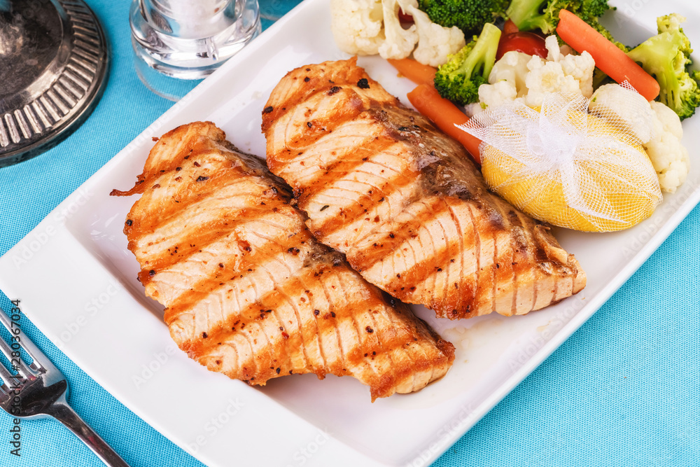Seafood, Mediterranean cuisine. Grilled Seafood Steak fish with greens, cucumber, lemon and chili. Japanese food Seafood, Mediterranean cuisine. Grilled Seafood Steak fish with greens, cucumber, lemon and chili. Japanese food