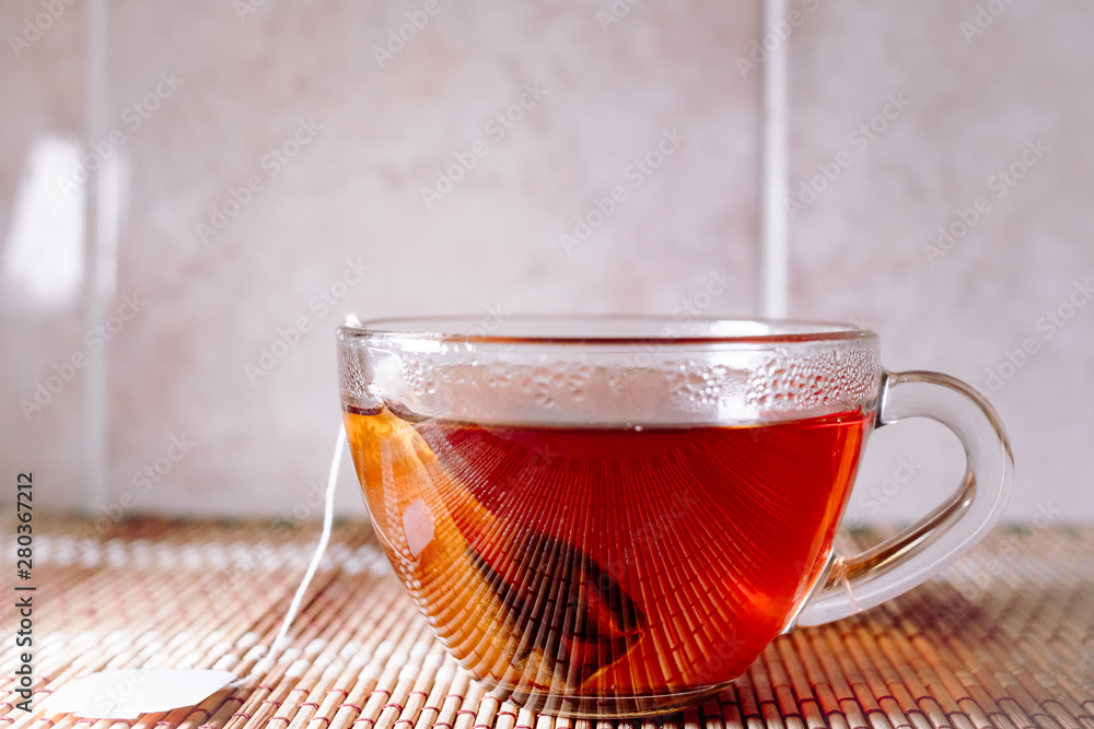 Fototapeta premium tea in a clear glass black