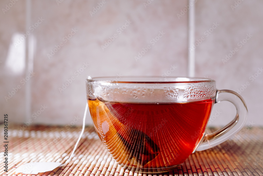 Fototapeta premium tea in a clear glass black